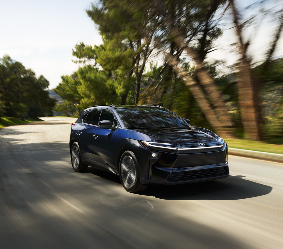 2026 Toyota bZ at Bobby Rahal Toyota in Mechanicsburg, PA | Dark blue 2026 Toyota bZ driving down a road during the day 2026 Toyota bZ at Bobby Rahal Toyota in Mechanicsburg, PA | Dark blue 2026 Toyota bZ driving down a road during the day