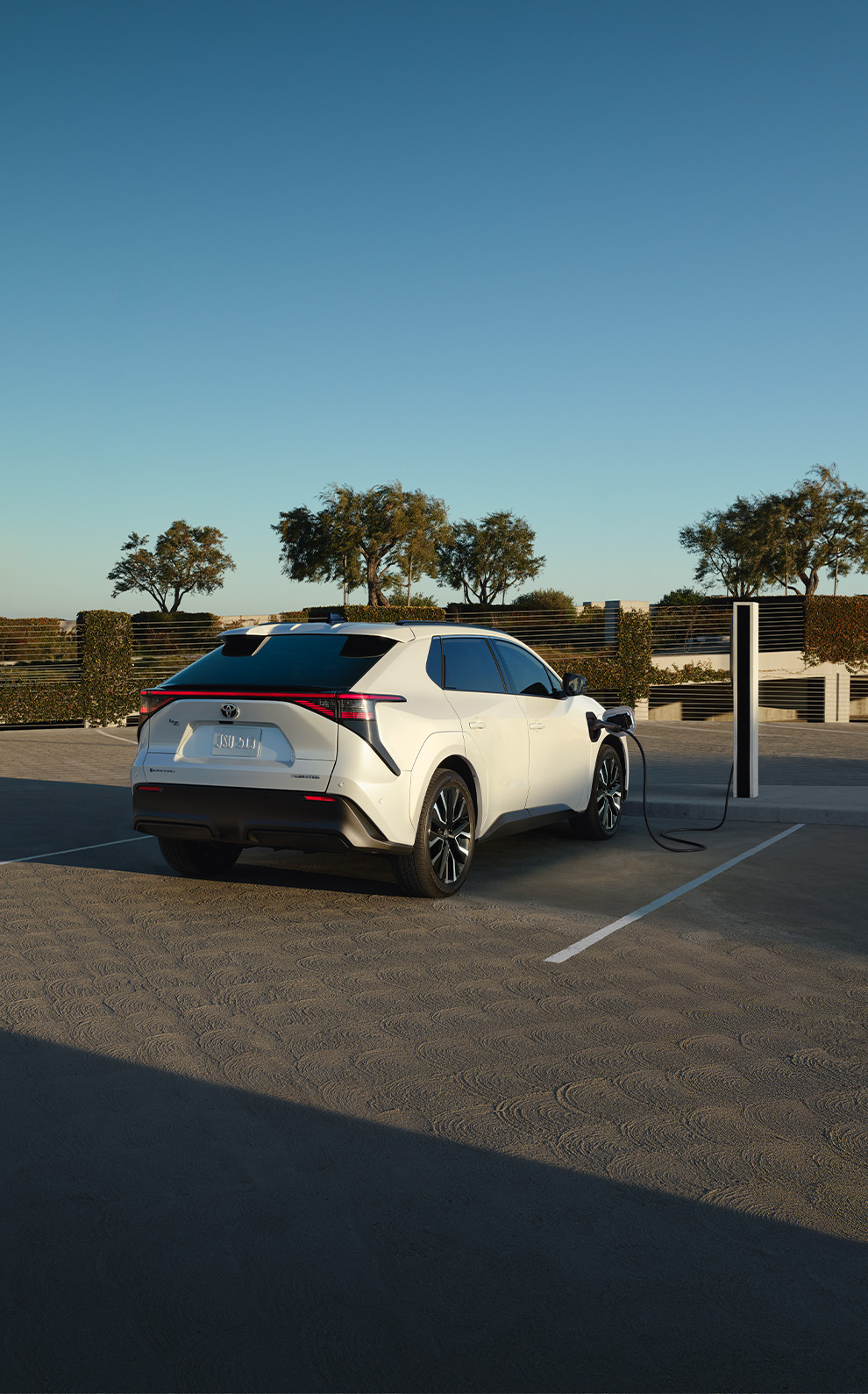 2026 Toyota bZ at Bobby Rahal Toyota in Mechanicsburg, PA | White 2026 Toyota bZ parked and charging next to charging port 2026 Toyota bZ at Bobby Rahal Toyota in Mechanicsburg, PA | White 2026 Toyota bZ parked and charging next to charging port