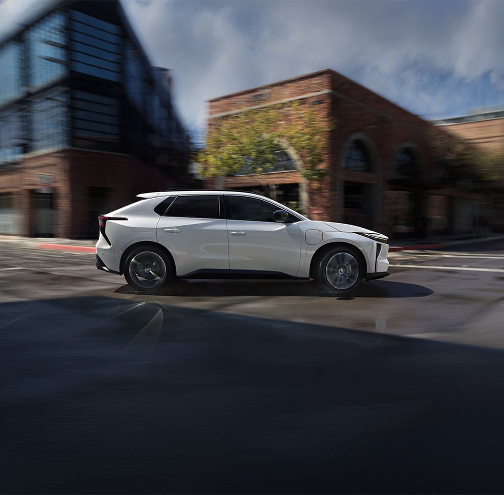 2026 Toyota bZ at Bobby Rahal Toyota in Mechanicsburg, PA | Side profile of a 2026 Toyota bZ making a turn at a street 2026 Toyota bZ at Bobby Rahal Toyota in Mechanicsburg, PA | Side profile of a 2026 Toyota bZ making a turn at a street