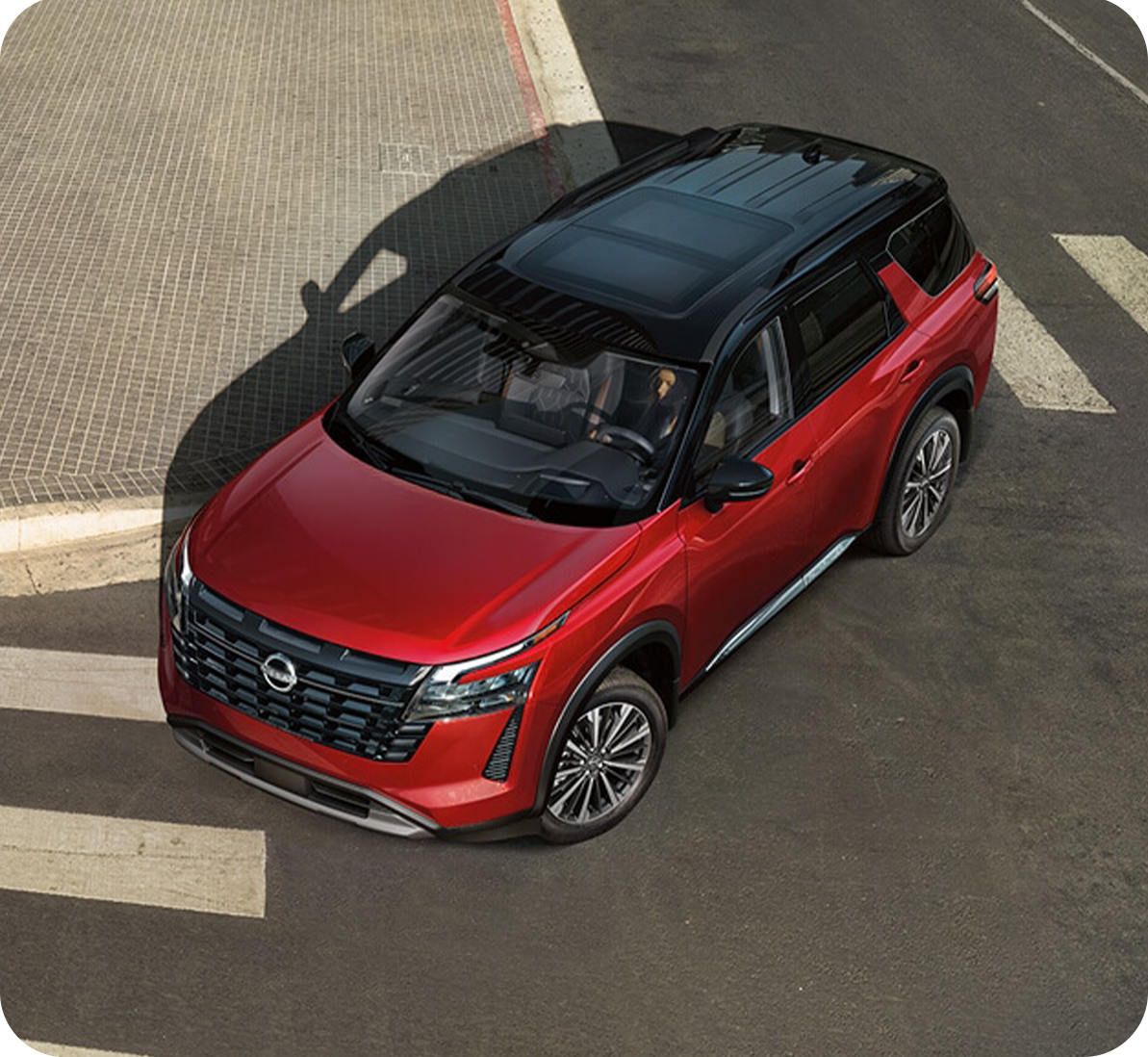 2025 Nissan Pathfinder at Timbrook Nissan | Top view of a red 2026 Nissan Pathfinder making a turn at the street 2025 Nissan Pathfinder at Timbrook Nissan | Top view of a red 2026 Nissan Pathfinder making a turn at the street