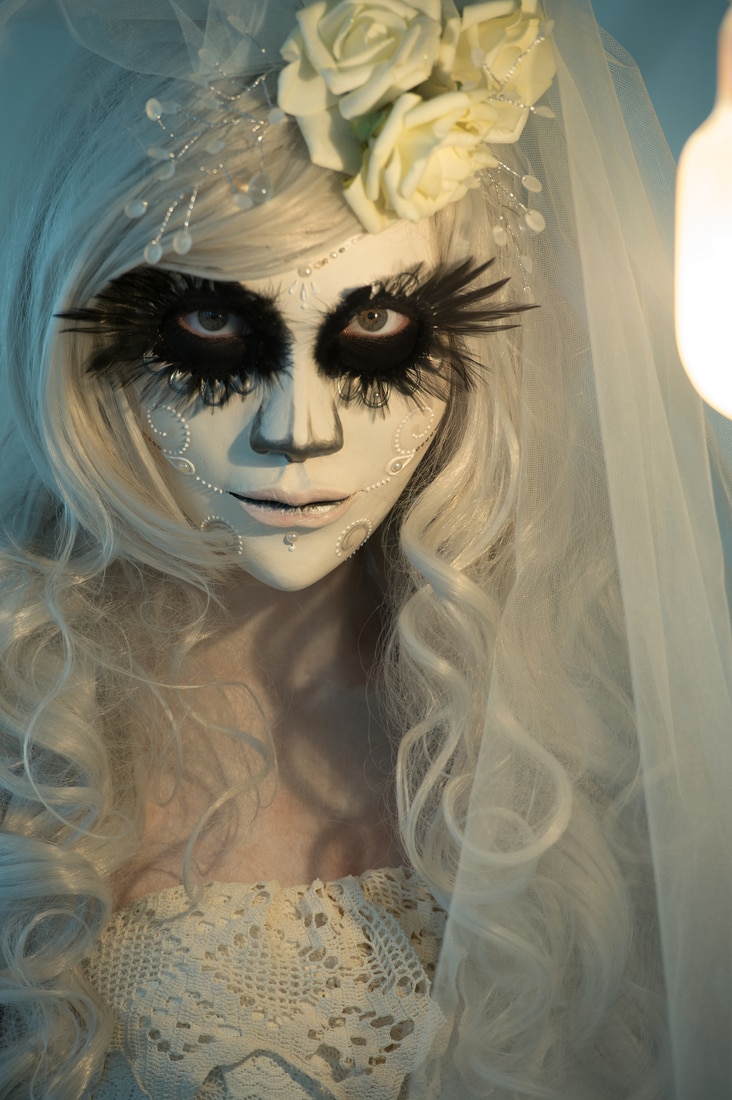 Halloween witch. Beautiful woman wearing santa muerte mask portrait. original halloween costume