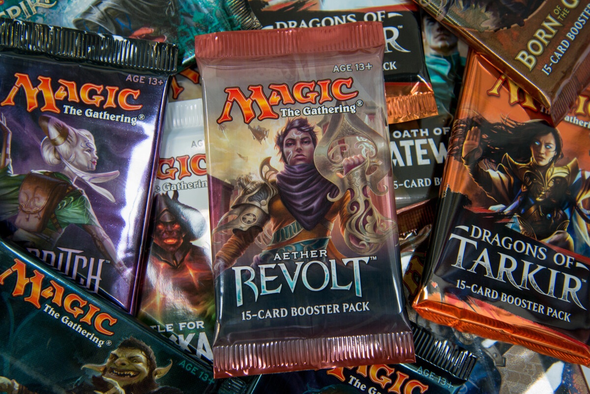 MTG booster packs from assorted sets including Aether Revolt and Dragons of Tarkir closeup
