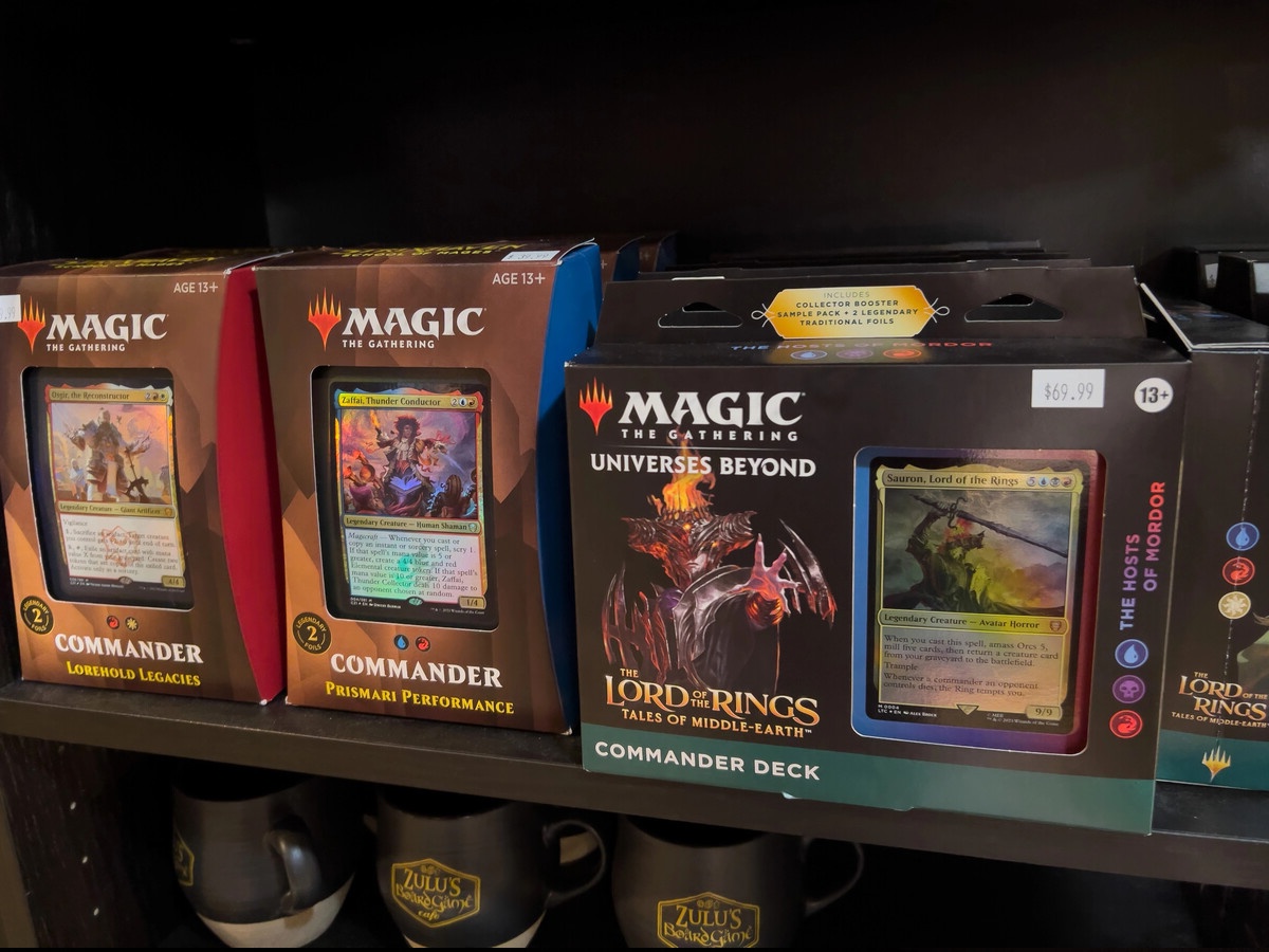 MTG Commander decks sealed on a retail shelf featuring Lord of the Rings Universes Beyond