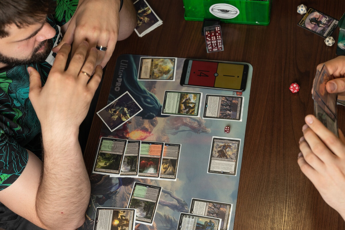 MTG two players match with cards spread on a playmat
