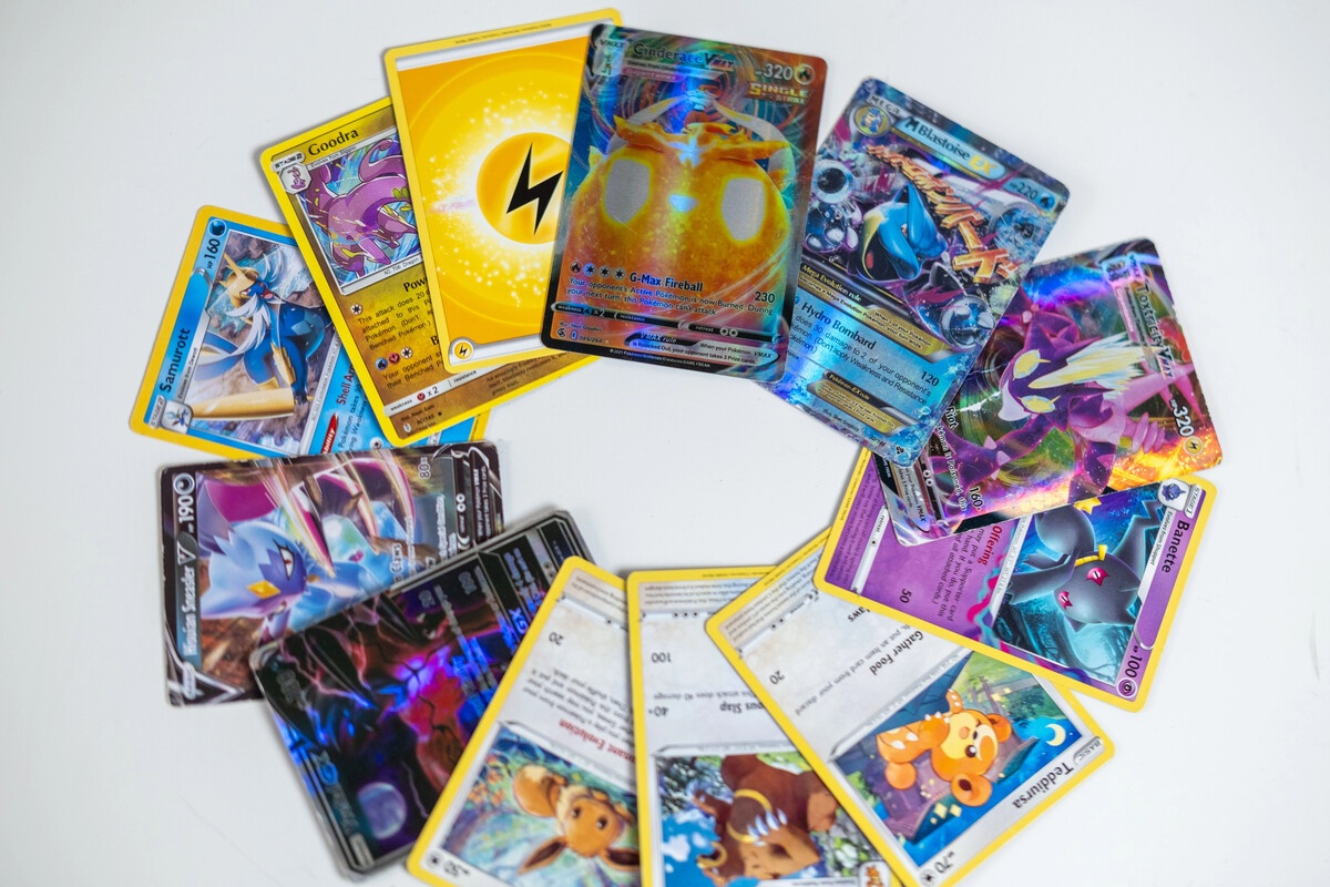 Pokemon cards spread in a semicircle showing holos and energy cards