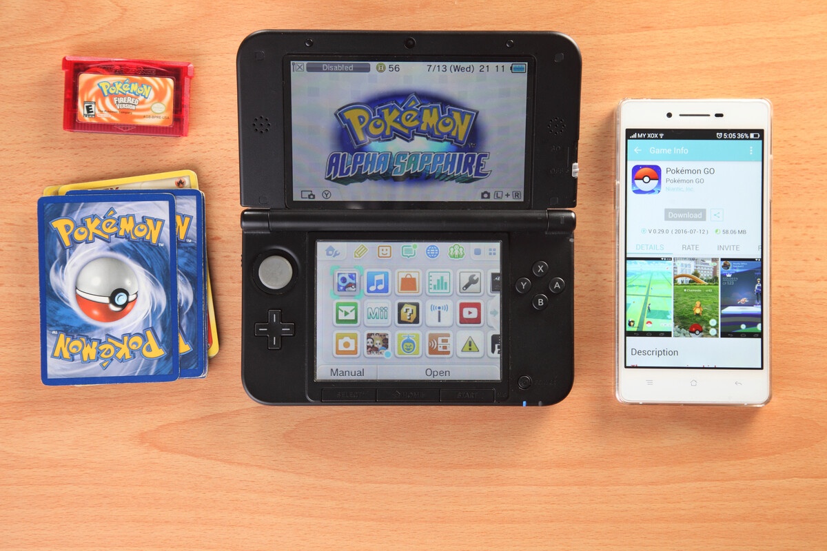 Pokemon multimedia ecosystem with 3DS Alpha Sapphire Pokemon Go TCG cards and GBA cartridge