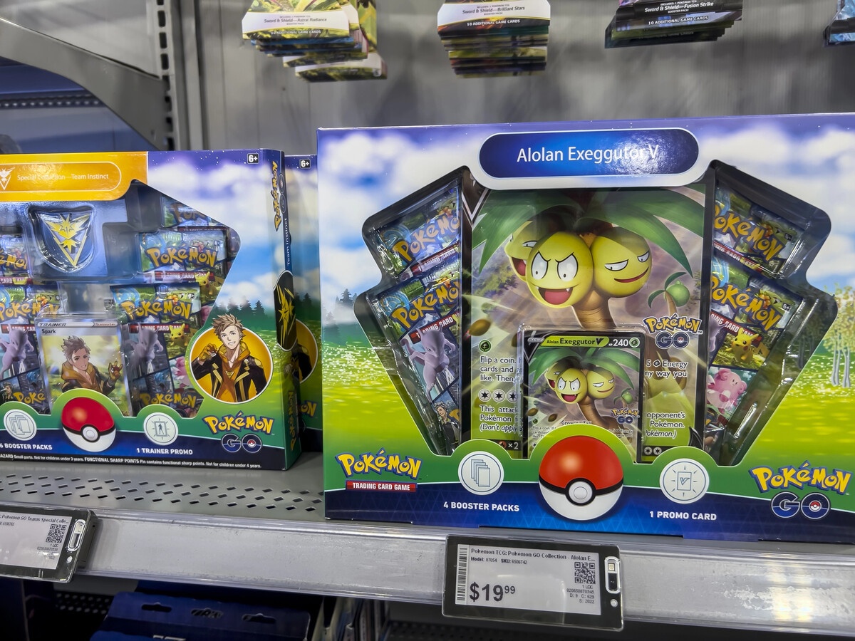 Pokemon TCG sealed product on a retail shelf with booster packs and collection boxes