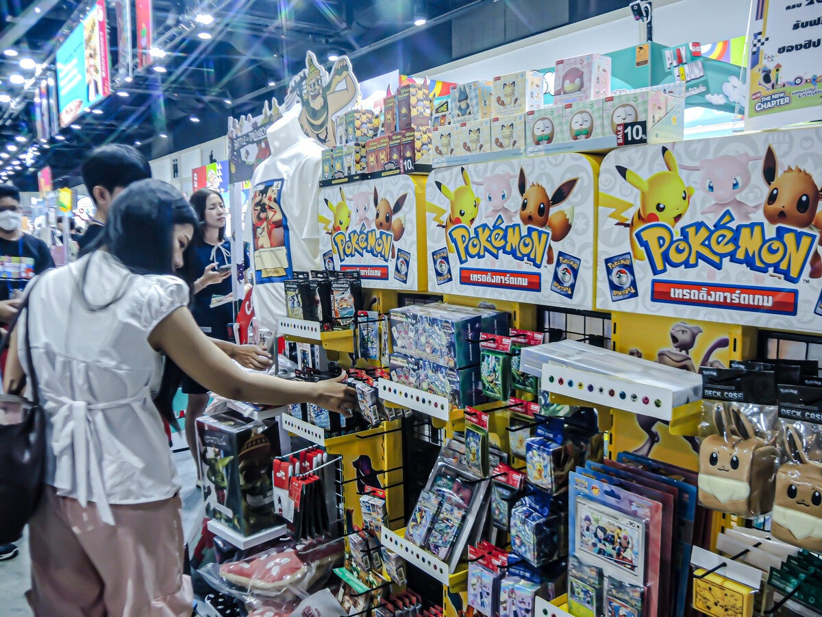Pokemon TCG vendor booth at a convention with people browsing sealed product