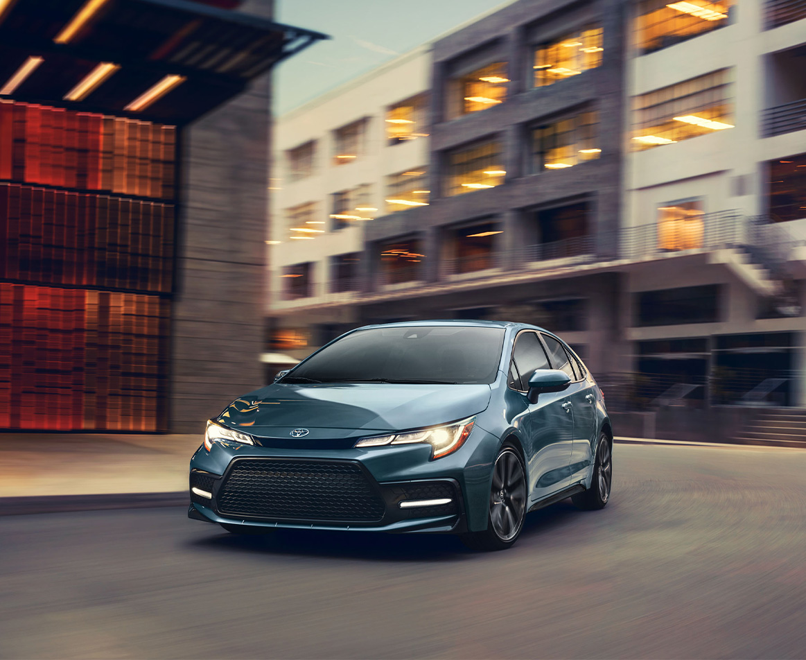 The New 2025 Toyota Corolla at Bobby Rahal Toyota in Mechanicsburg, PA | Blue 2025 Toyota Corolla making a sharp turn at a city street
