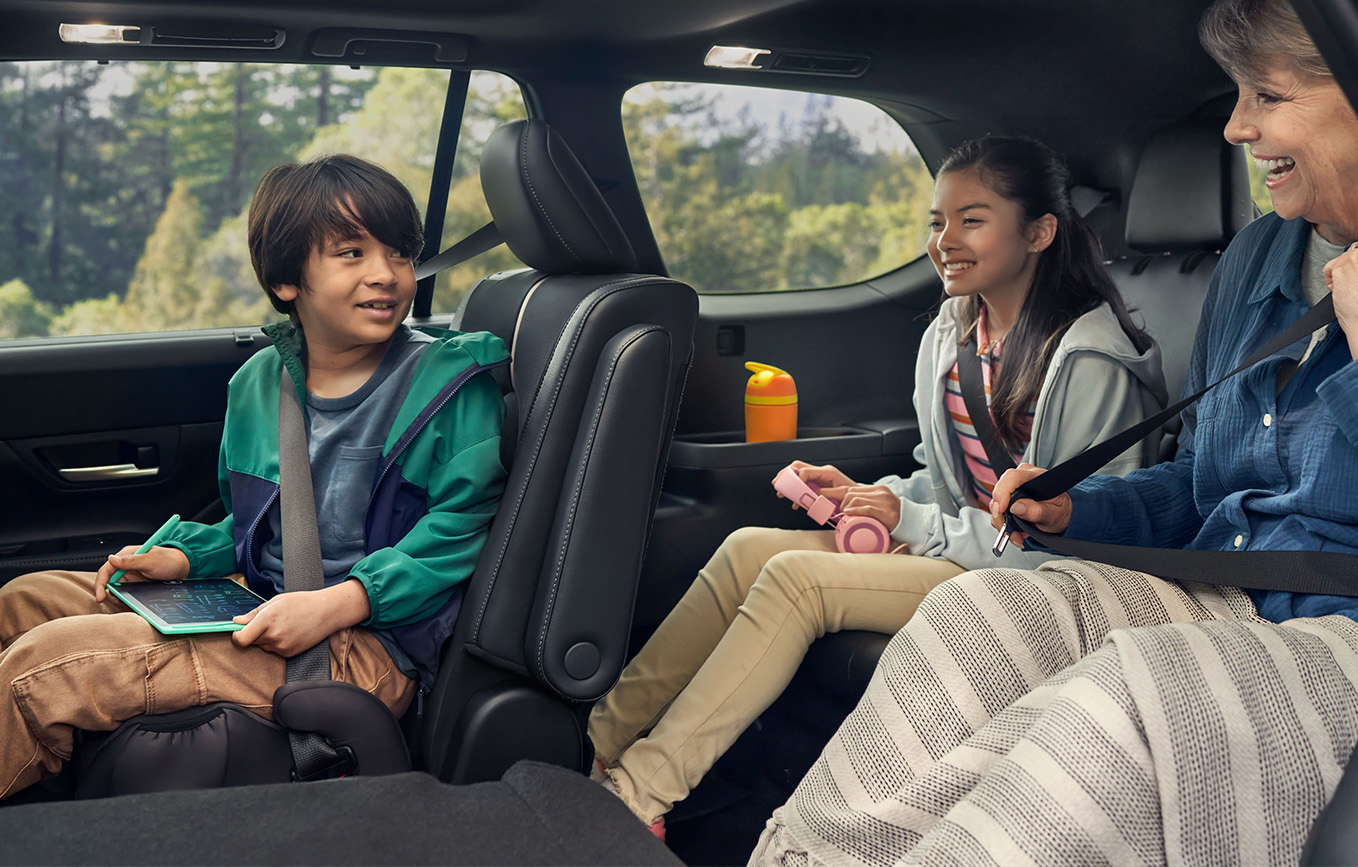 2025 Toyota Grand Highlander vs 2025 Subaru Ascent comparison | Bobby Rahal Toyota | Family sitting the back seats of the 2025 Toyota Grand Highlander
