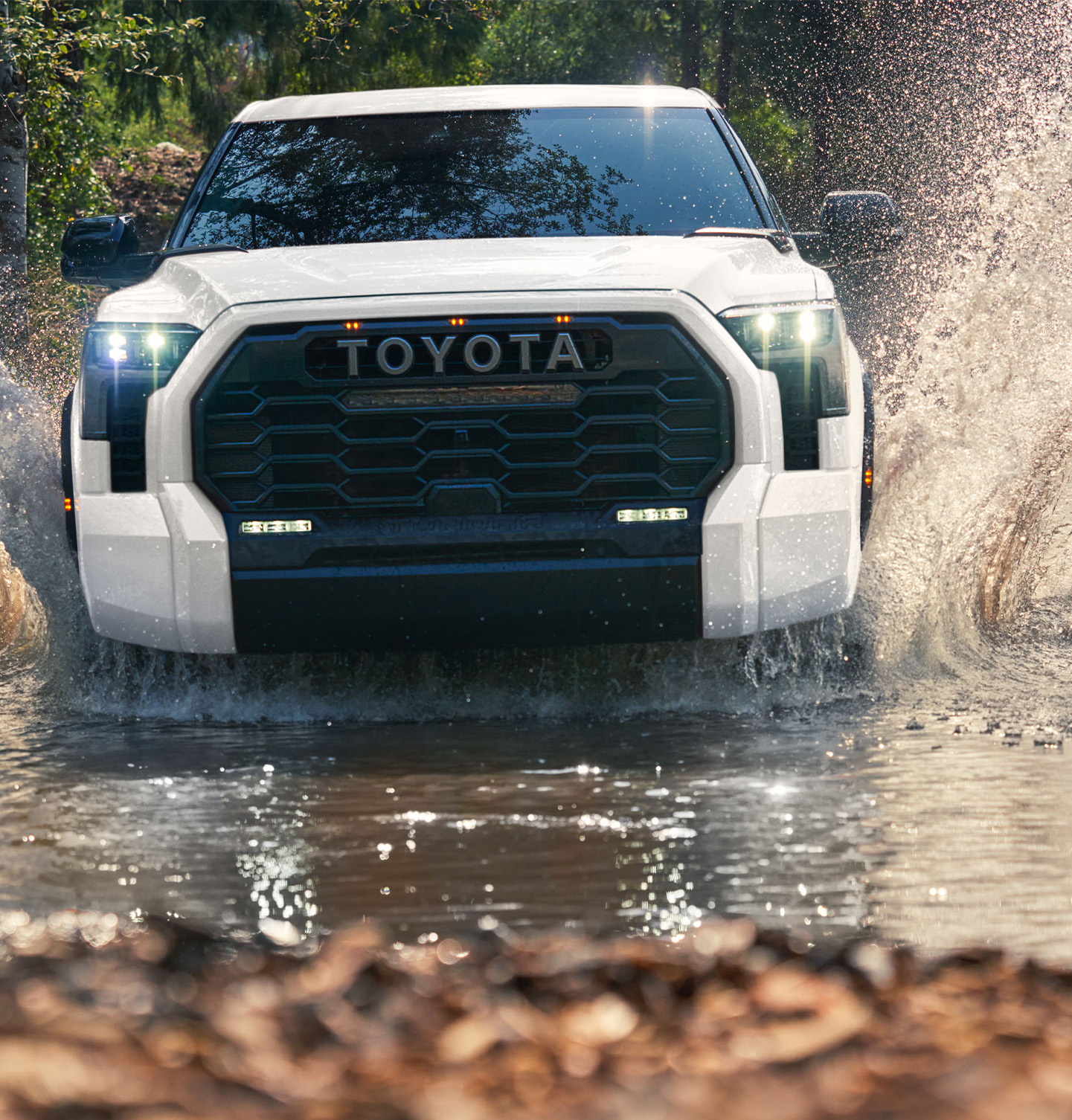 The New 2025 Toyota Tundra at Bobby Rahal Toyota in Mechanicsburg, PA | White 2025 Toyota Tundra driving through some water