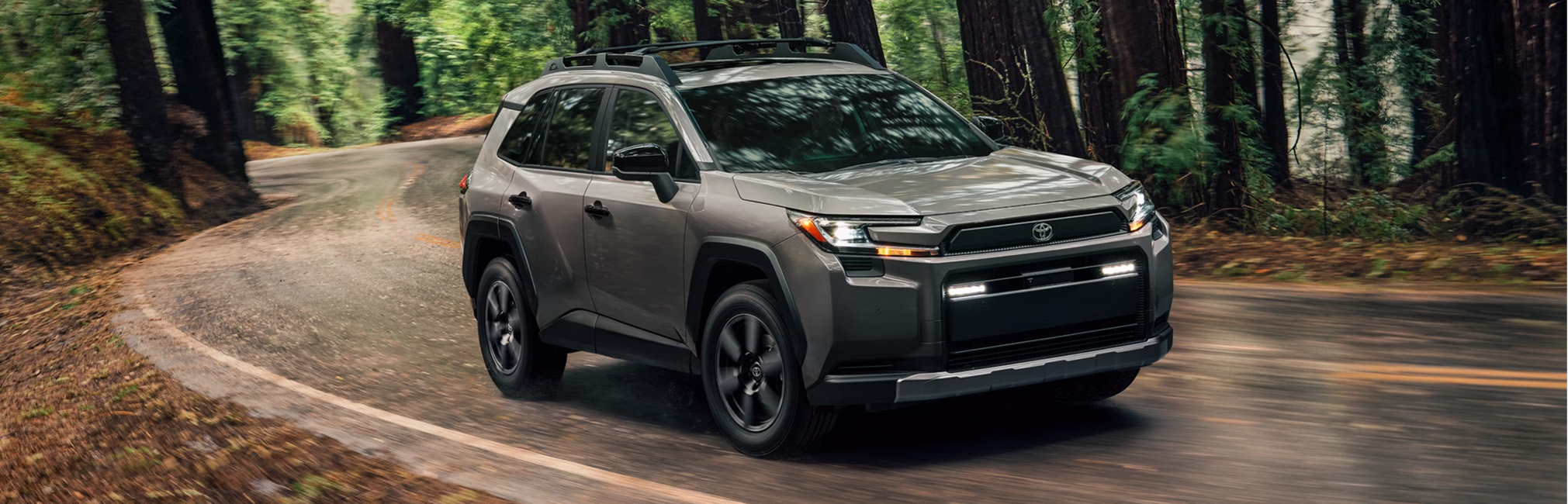 2026 Toyota RAV4 at CMA's Toyota of Martinsburg in Martinsburg, WV | 2026 Toyota RAV4 driving down a curvy road