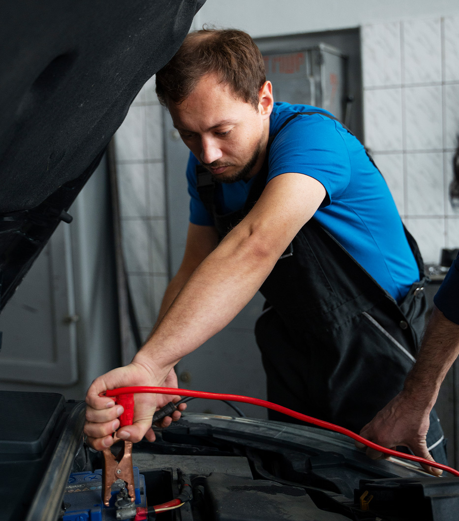 How to Jump Start a Car |  CMA's Toyota of Martinsburg in Martinsburg, WV | Man in blue shirt attaching jumper cables to car battery