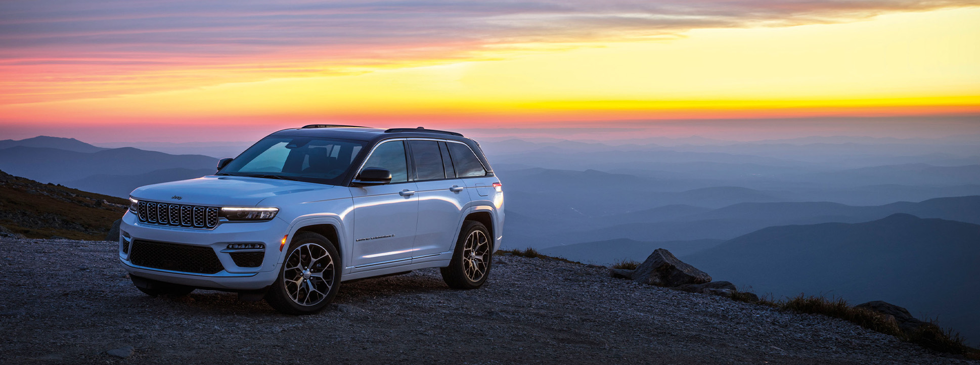 2025 Jeep Grand Cherokee at Delaney CDJR of DuBois | White 2025 Jeep Grand Cherokee parked at the top of a hill while the sun is setting