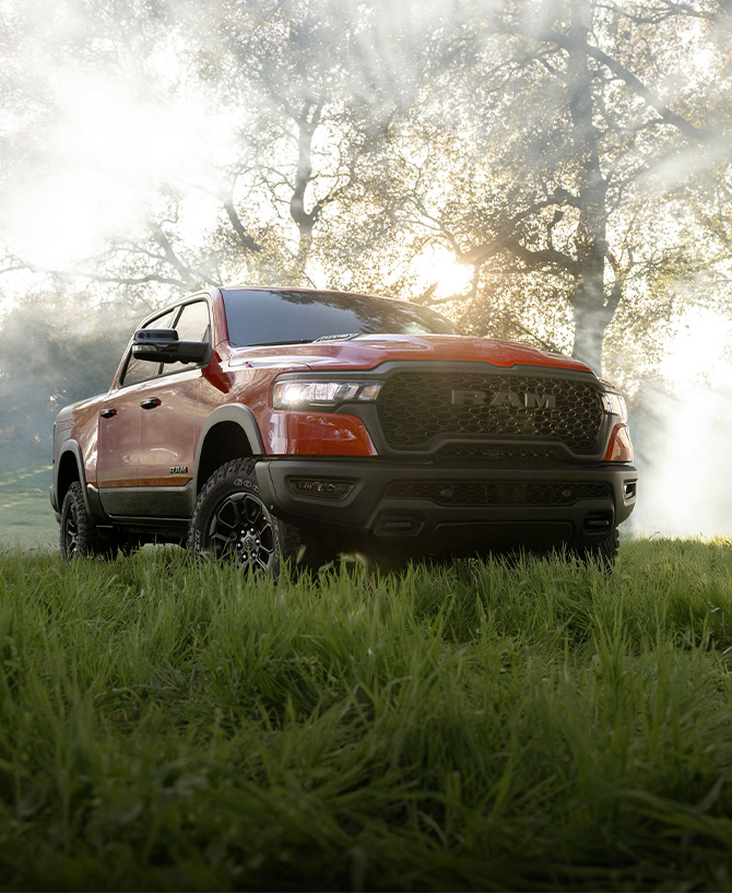 2025 Ram 1500 at Delaney CDJR of DuBois | 2025 red RAM 1500 parked in the middle of a field
