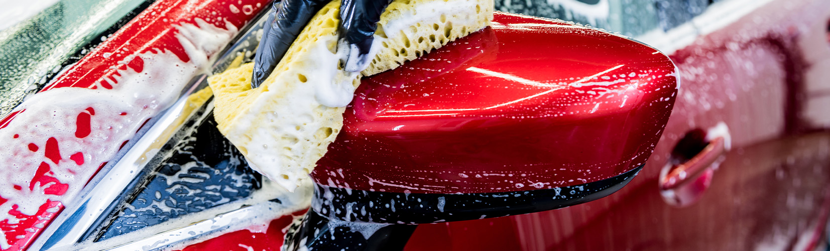 Tips for spring cleaning your car at Delaney CDJR of DuBois in DuBois, PA | Washing car with soap and sponge