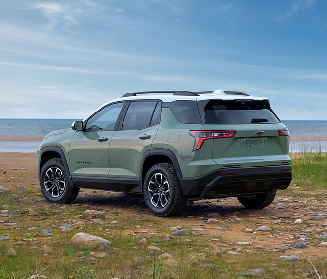 2025 Chevrolet Equinox at Delaney Chevrolet of Greensburg | Rear profile of a green 2025 Chevy Equinox parked on the sand of a beach