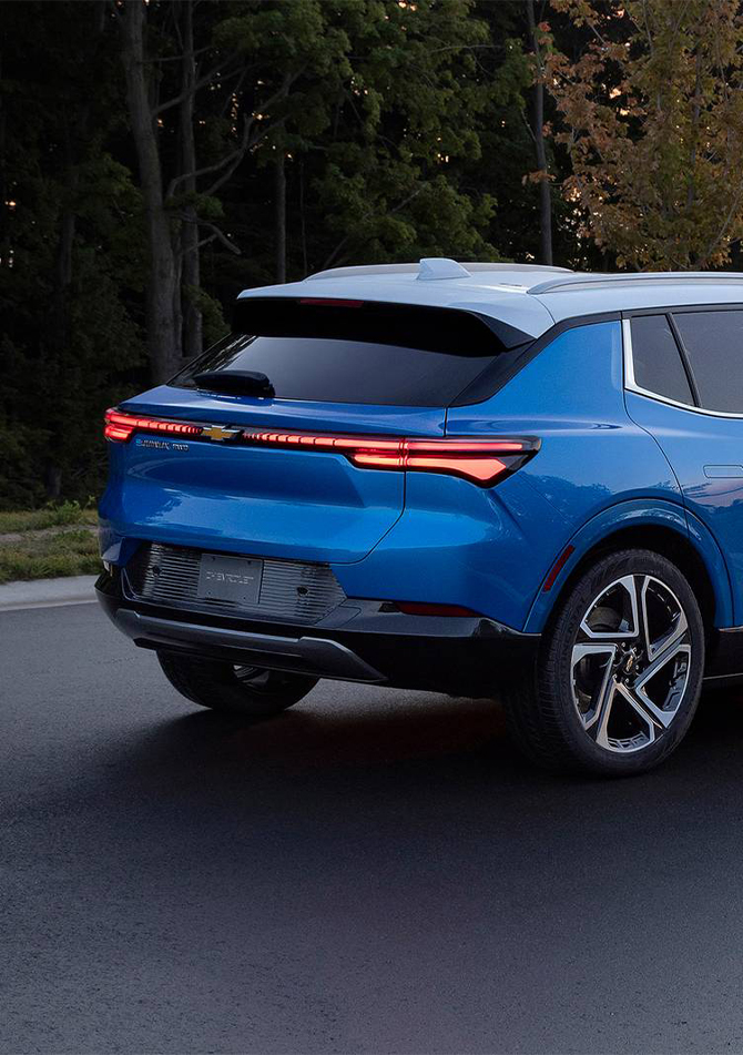 2026 Chevrolet Equinox at Delaney Chevrolet of Greensburg | Rear profile of a blue 2026 Chevy Equinox with the tail lights on