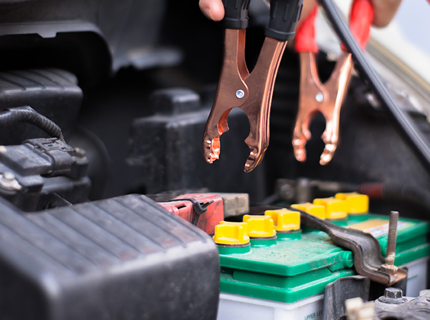 Everything You Need to Know about Your Car Battery at Delaney Chevrolet of Indiana | Jumper cables about to be attached to car battery 