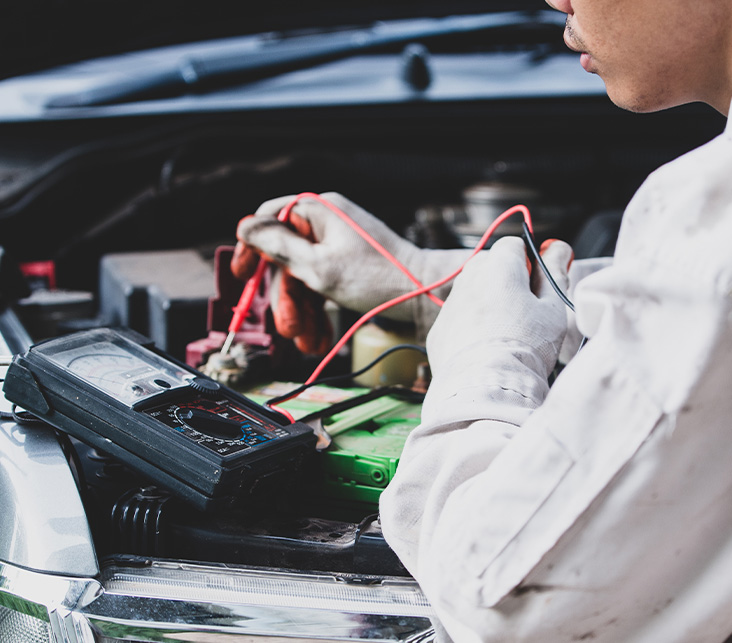 Everything You Need to Know about Your Car Battery at Delaney Chevrolet of Indiana |  Mechanic testing the battery voltage of car battery 