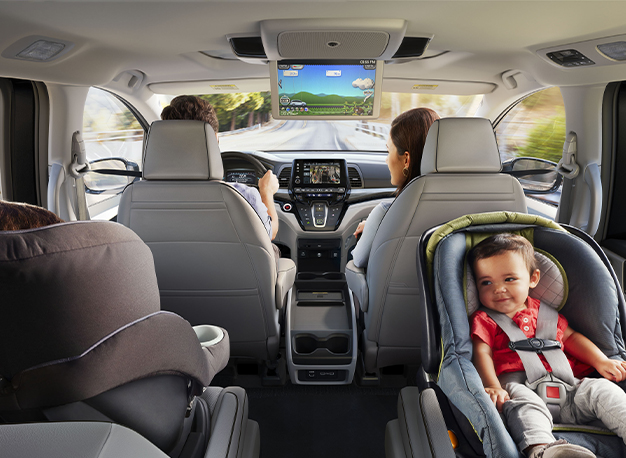 New 2025 Honda Odyssey at Delaney Honda | Interior of the back seats of a 2025 Honda Odyssey with kids seats in the back