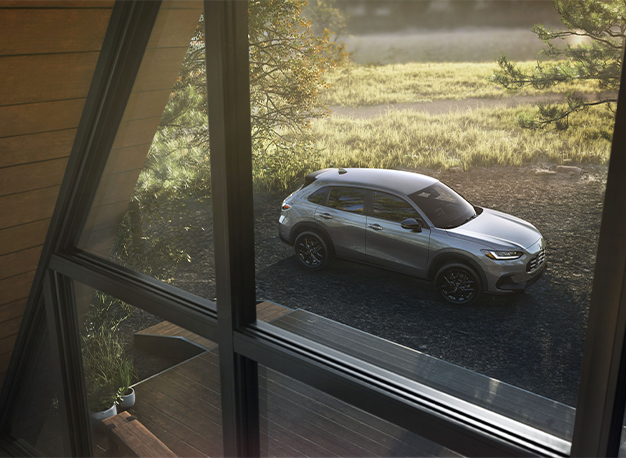 New 2025 Honda HR-V at Delaney Honda | Silver color 2025 Honda HR-V parked outside of house