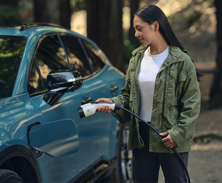 How to prepare your home for your new Electric Vehicle at Delaney Honda in Indiana, PA | Woman plugging in her home car charger nozzle into her 2025 Honda Prologue