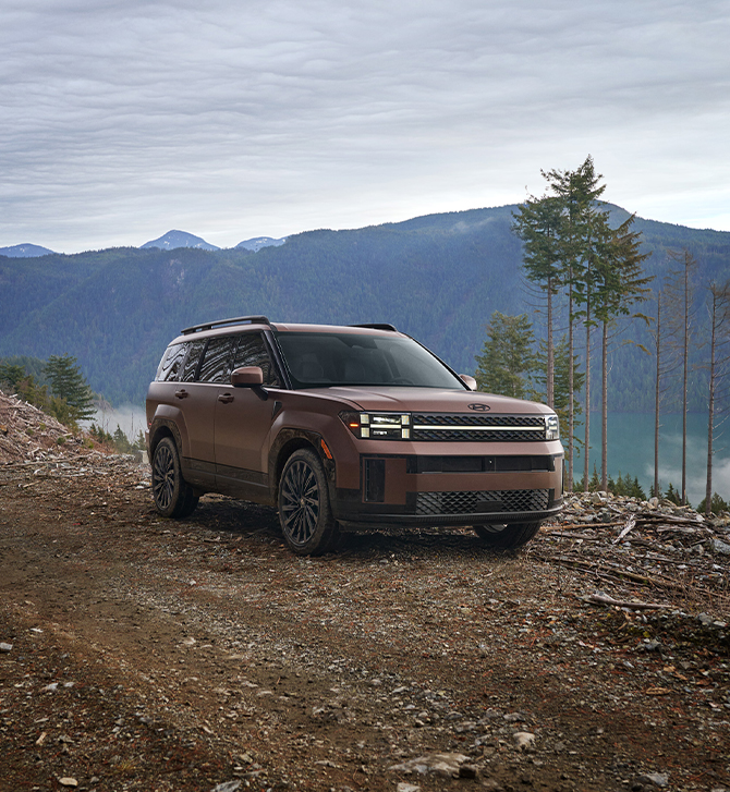 2025 Hyundai Santa Fe at Delaney Hyundai of Dubois | Brown 2025 Hyundai Santa Fe driving on a trail in the mountains