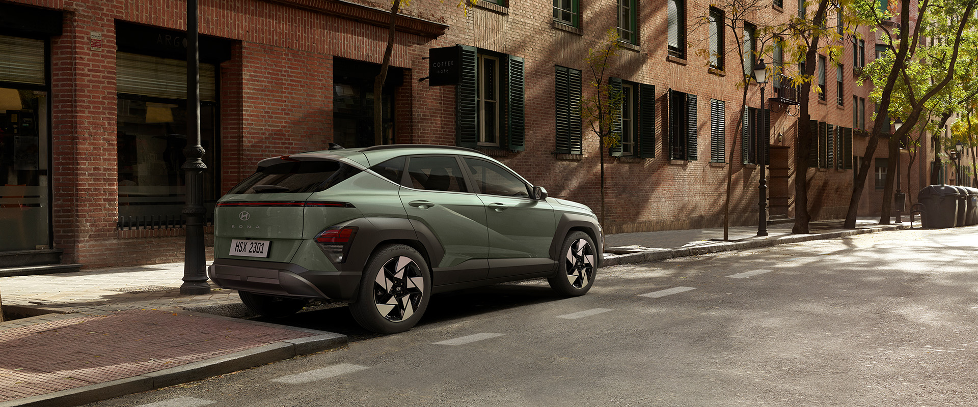 2025 Hyundai Kona at Delaney Hyundai of Indiana | Green 2025 Hyundai Kona Parked On Street Next to Brick Building