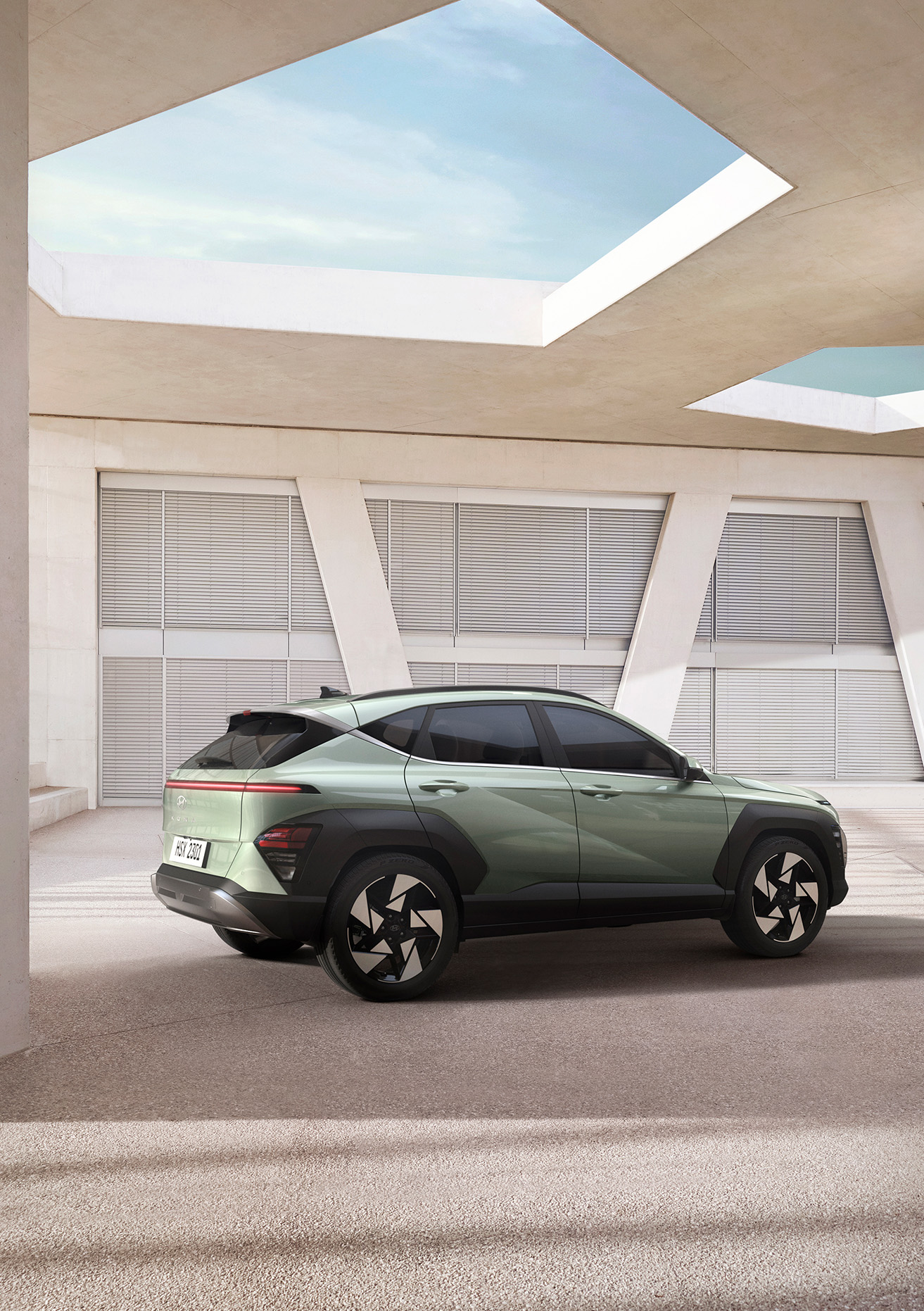 2025 Hyundai Kona at Delaney Hyundai of Indiana | Green 2025 Hyundai Kona Parked Inside of Bright White Parking Garage