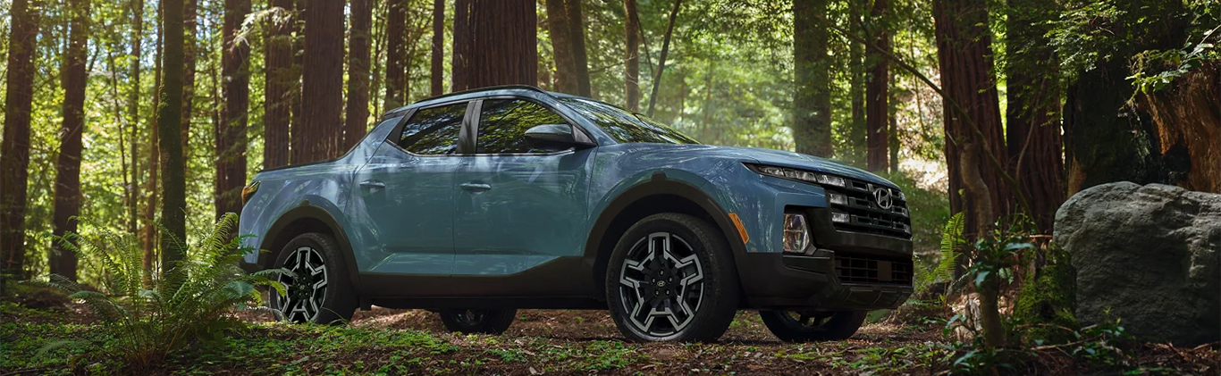  2025 Hyundai Santa Cruz at Delaney Hyundai of Indiana | Blue 2025 Hyundai Santa Cruz parked in the middle of a trail in the forest 
