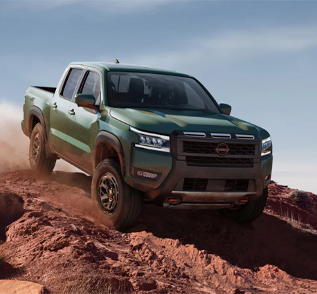 2025 Nissan Frontier at Delaney Nissan of Greensburg | Green 2025 Nissan Frontier driving down a hill 2025 Nissan Frontier at Delaney Nissan of Greensburg | Green 2025 Nissan Frontier driving down a hill