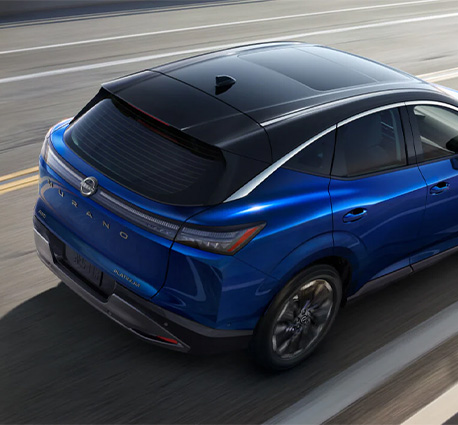 2025 Nissan Sentra at Delaney Nissan of Greensburg | rear profile of a blue 2025 Nissan Murano driving by