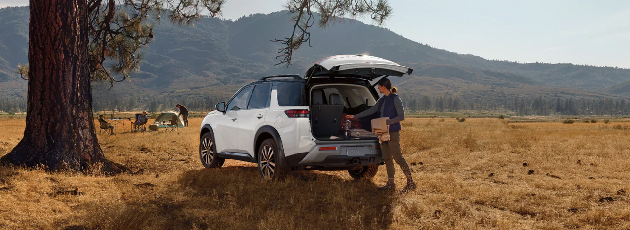 2025 Nissan Pathfinder at Delaney Nissan of Greensburg | Woman unpacking from the trunk of her white 2025 Nissan Pathfinder