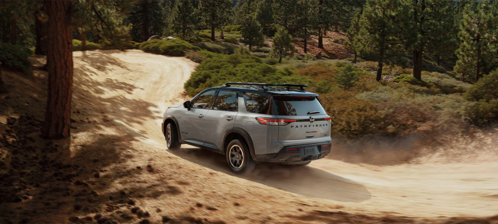 2025 Nissan Pathfinder at Delaney Nissan of Greensburg | Rear profile of a 2025 Nissan Pathfinder driving up hill