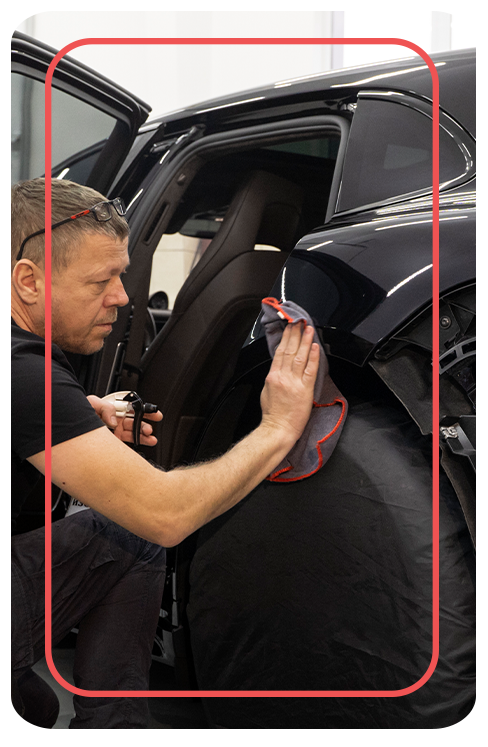 How to Prepare to Trade in Your Car |  Delaney Nissan of Greensburg in Greensburg, PA | Man cleaning the exterior of his car with microfiber towel