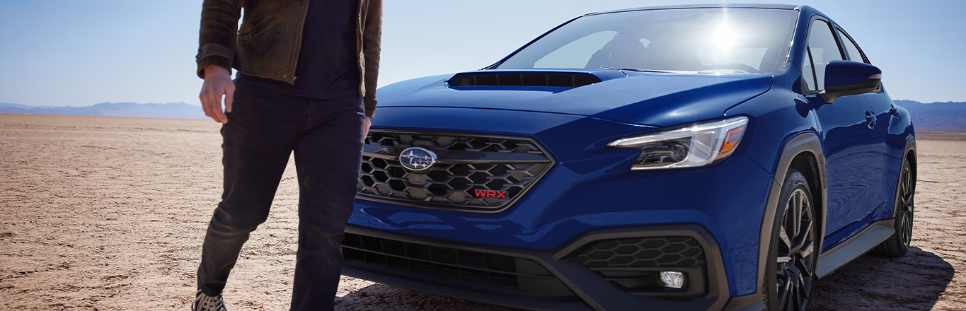 2025 Subaru WRX at Delaney Subaru in Indiana, PA | Man walking past his parked 2025 Subaru WRX in the color blue