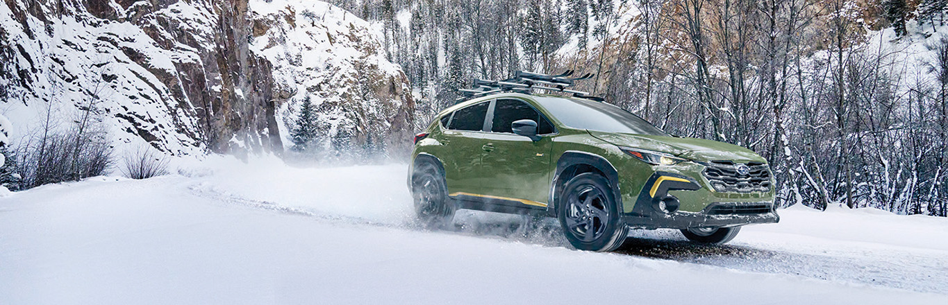 2026 Subaru Crosstrek at Delaney Subaru in Indiana, PA | Green 2026 Subaru Crosstrek driving through the snow in winter