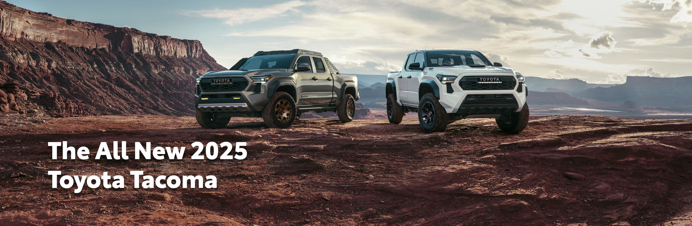 2025 Toyota Tacoma at Delaney Toyota of DuBois in DuBois, PA | Two 2025 Toyota Tacomas parked side by side on top of a rocky hill