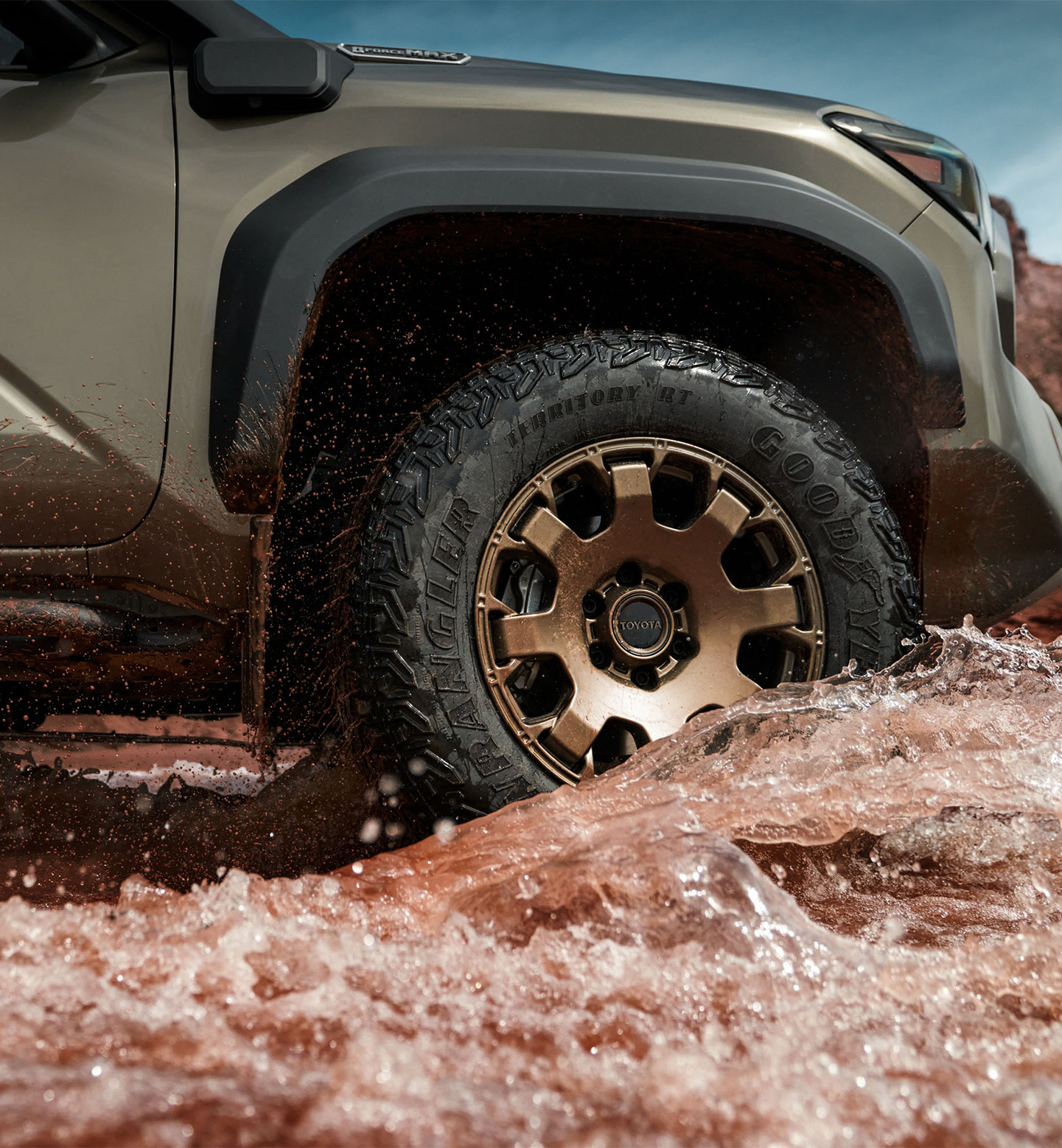 2025 Toyota Tacoma at Delaney Toyota of DuBois in DuBois, PA | Close up of some bronze color rims for a 2025 Toyota Tacoma driving through some dirt water