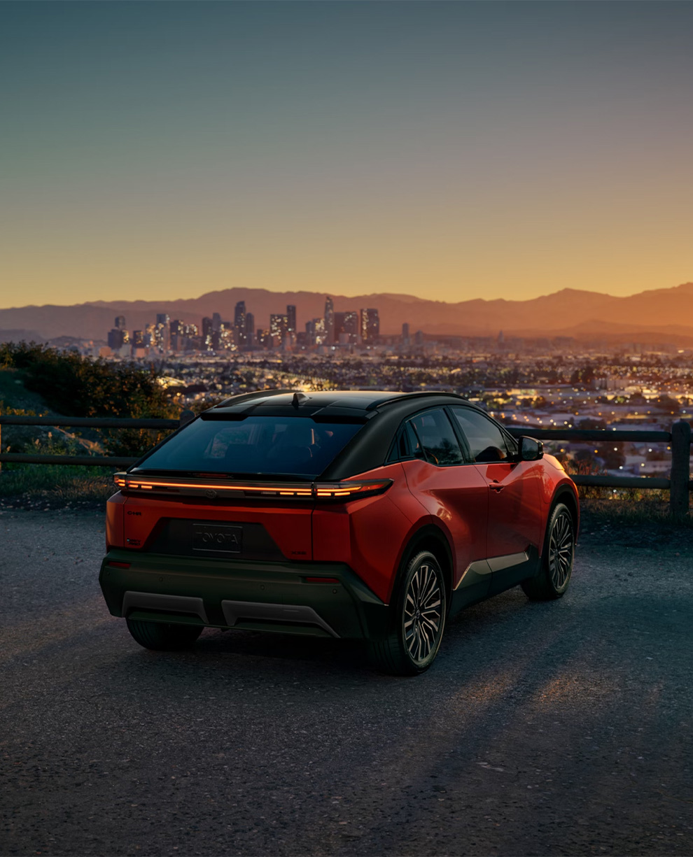 2026 Toyota CH-R at Delaney Toyota of DuBois in DuBois, PA | Rear profile of a 2026 Toyota CH-R with a view of the city 2026 Toyota CH-R at Delaney Toyota of DuBois in DuBois, PA | Rear profile of a 2026 Toyota CH-R with a view of the city