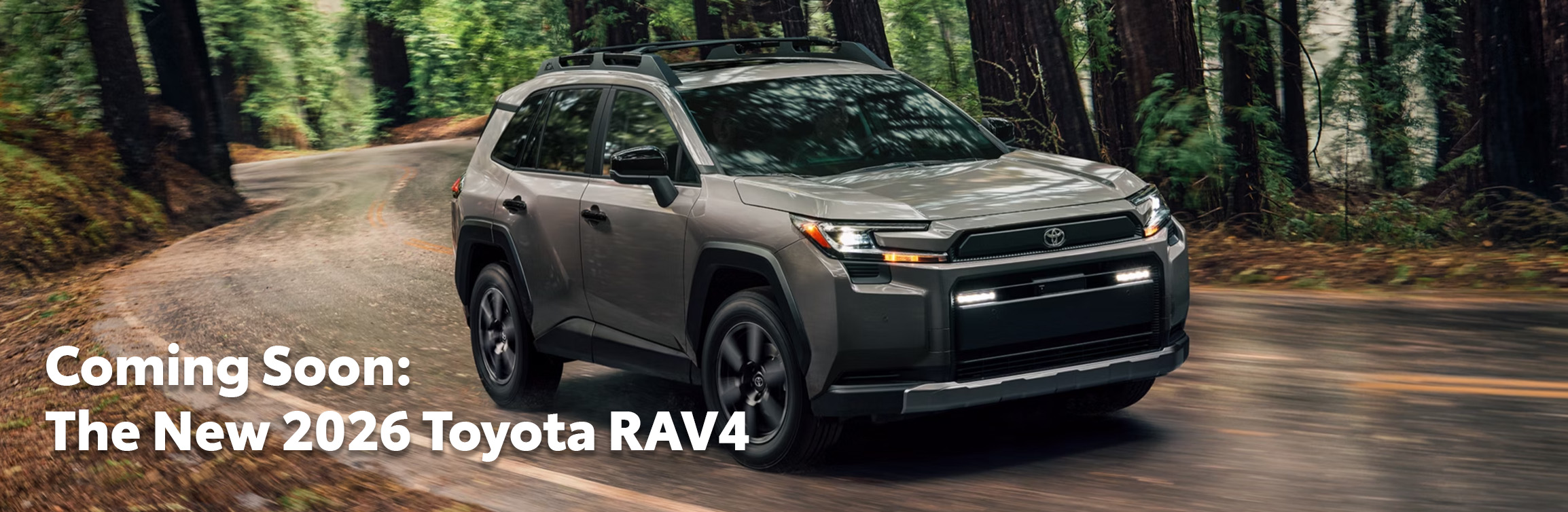 2026 Toyota RAV4 at Delaney Toyota of DuBois in DuBois, PA | 2026 Toyota RAV4 driving down a curvy road 2026 Toyota RAV4 at Delaney Toyota of DuBois in DuBois, PA | 2026 Toyota RAV4 driving down a curvy road