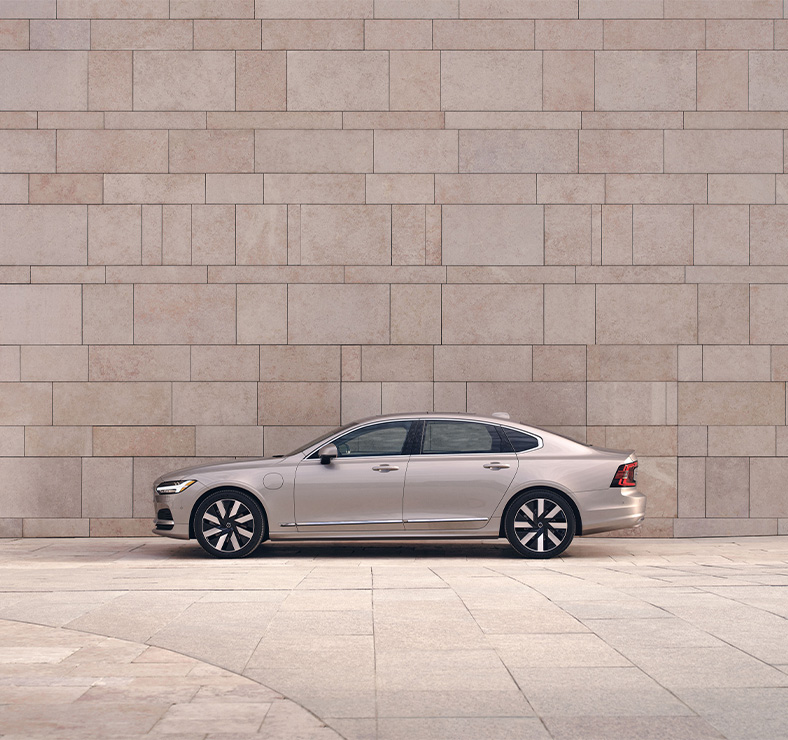 2025 Volvo S90 | side profile of a 2025 Volvo S90 plug-in hybrid in the color beige