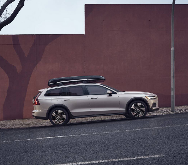 2025 Volvo V60 | Side profile of a 2025 Volvo V60 driving up a hill
