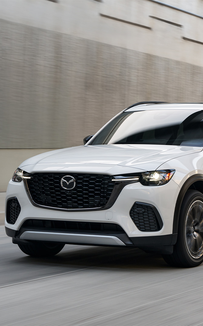 2026 Mazda CX-70 & Mazda CX-70 PHEV at Lancaster Mazda | Front profile of a white 2026 Mazda CX-70 2026 Mazda CX-70 & Mazda CX-70 PHEV at Lancaster Mazda | Front profile of a white 2026 Mazda CX-70