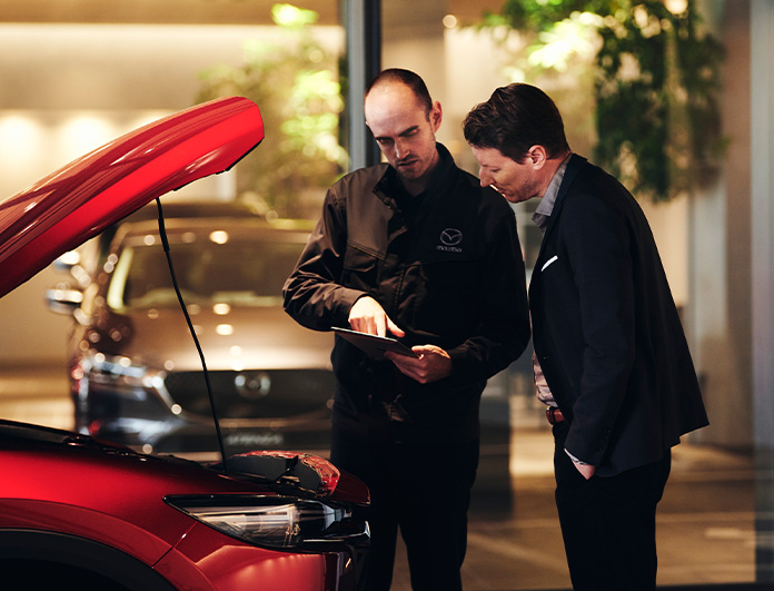 Check Engine Light Diagnostics at Lancaster Mazda | Service advisor talking to customer about their car service needed for their Mazda vehicle