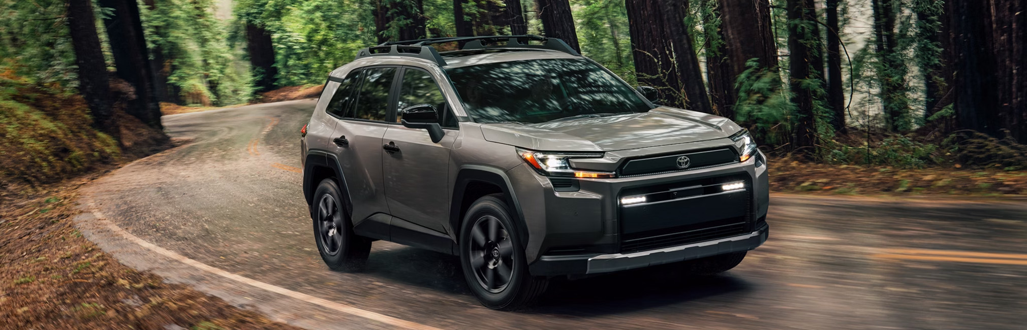 2026 Toyota RAV4 at Lancaster Toyota in East Petersburg, PA | Brand new 2026 Toyota RAV4 driving on a curvy road 2026 Toyota RAV4 at Lancaster Toyota in East Petersburg, PA | Brand new 2026 Toyota RAV4 driving on a curvy road