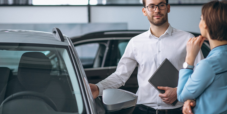 The Advantages of Buying a Car from a Dealership vs. a Private Seller. Learn more at Mechanicsville Toyota in Mechanicsville, VA |  Sales person with glasses is showing a customer the car options at the dealership