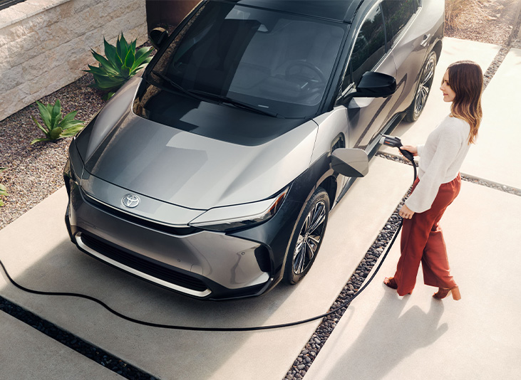 How to prepare your home for your new Electric Vehicle at Mechanicsville Toyota in Mechanicsville, VA | Woman charging her Toyota bz4x