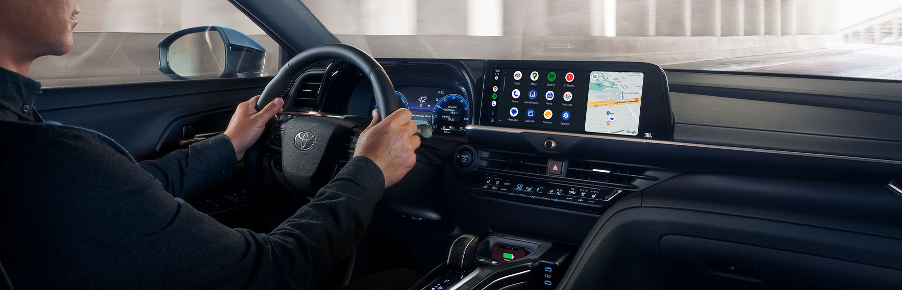 Android Auto vs. Apple CarPlay at Palmiero Toyota in Meadville, PA | Man driving his Toyota vehicle while android auto is displayed